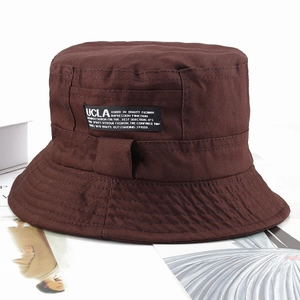 Detailed view of brown cotton bucket hat featuring UCLA embroidered label on the side
