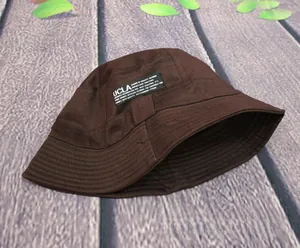 Detail of dark brown cotton bucket hat featuring a UCLA woven label on the side