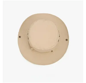 Top view of beige wide brim sun hat with ventilation eyelets and foldable metal snaps