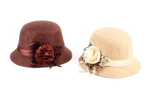 Detail of linen cloche hats with decorative fabric flowers and vintage mesh veil accents