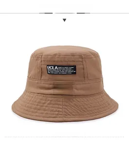 Detail of a brown cotton bucket hat featuring a UCLA fabric patch and stitched brim