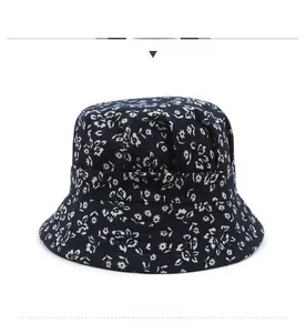 Detailed front view of navy blue floral bucket hat with white daisy print patterns
