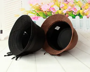 Detail of linen dome hats in black and brown colors with decorative ribbon bows