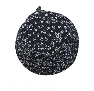 Top down macro view of navy blue floral bucket hat with black adjustable drawstring cord
