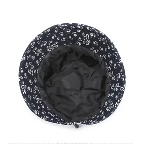 Detail of floral bucket hat interior featuring black lining and adjustable drawstring cord