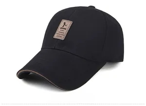 Detail view of cotton baseball cap featuring brown leather EDIKO patch and curved brim