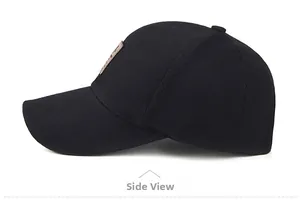 Detailed side view of black cotton baseball cap with extended brim and leather logo patch