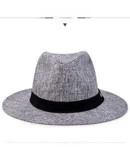 Close-up of a grey woven fedora hat featuring a black band and detailed linen texture