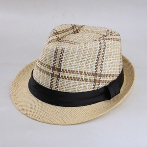 Close-up of woven straw fedora featuring a plaid crown and black satin ribbon band