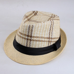 Detailed view of the woven plaid crown and black velvet ribbon on a summer straw fedora hat