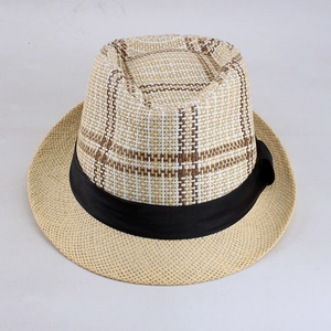 Detail of checkered woven texture and black ribbon on a summer straw fedora hat