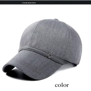 Detail view of dark gray baseball cap with textured fabric and small metal shield logo