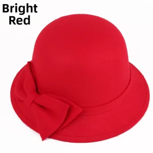 Detailed close-up of a red wool felt cloche hat featuring an elegant layered side bow