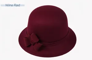 Detail of a wine red wool cloche hat with an elegant bow accent for women
