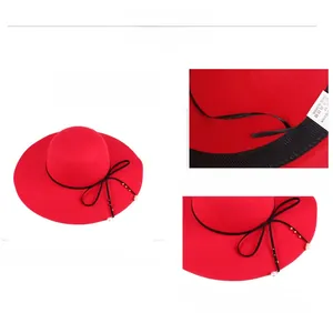 Detail of red wide-brim wool hat featuring pearl bow knot and adjustable inner band