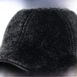 Detail of premium black faux mink fur texture on men's winter cap for windproof warmth