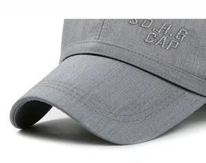 Detail of gray linen baseball cap with S.D.H.G CAP embroidery and stitched brim