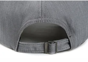 Detail of adjustable metal buckle on grey linen baseball cap for custom head sizing