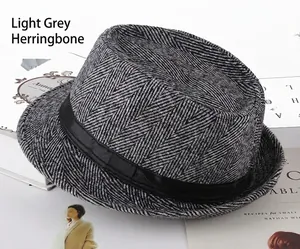 Close-up of light grey herringbone fabric texture on classic men fedora hat