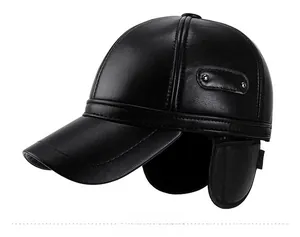 Detail of black faux leather winter baseball cap with foldable earflaps and metal rivets