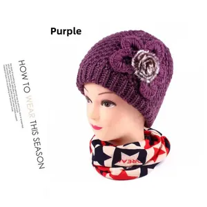 Detail of purple knitted winter hat with floral accent and star pattern scarf set