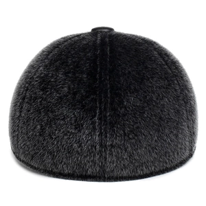 Macro texture of black faux fur baseball cap featuring a premium leather top button detail