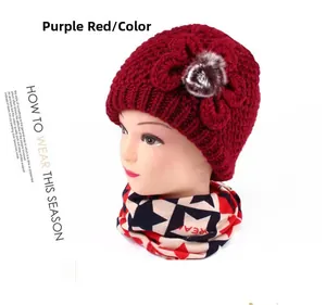 Detail of purplish red thick knit hat for elderly women with floral accent and pompom
