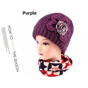 Detailed view of purple thick knit hat with crochet flower and DREAM star scarf set