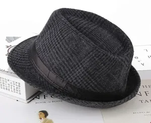Detailed view of grey herringbone pattern fedora with elegant black satin ribbon band