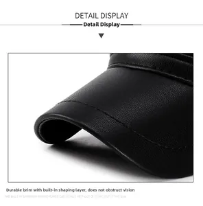 Detail view of the black lychee pattern leather brim with firm stitching on a men's winter cap