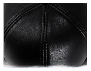Detailed macro view of high-quality black leather cap top with durable double stitching