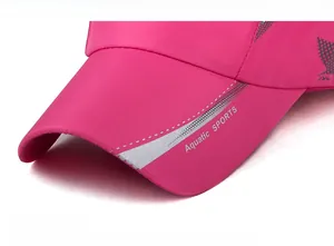 Detailed close-up of rose red sports cap brim with Aquatic Sports white text printing