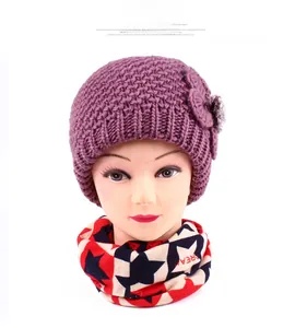 Detailed close-up of purple knit hat with side flower and star pattern tube scarf