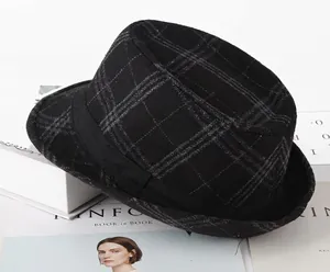 Close-up of vintage large black plaid gentleman hat with woolen texture on a magazine
