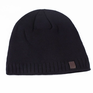 Men's winter black knitted beanie hat with a vintage sport star leather patch detail