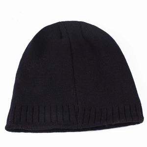 Close-up of black knitted beanie showing detailed fine rib texture and warm cotton fabric