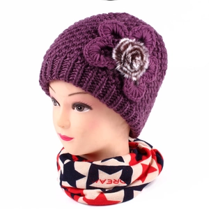 Detail of purple winter knit hat with floral decoration and star patterned scarf set