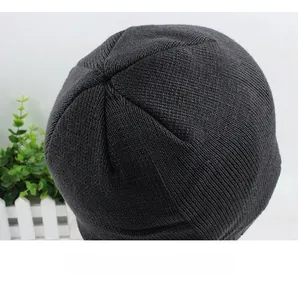 Detail view of the six-panel 3D stitching on the crown of a black knitted beanie hat