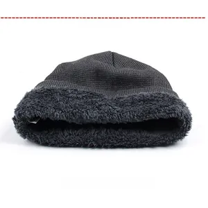 Detail of grey winter beanie showing thick fleece lining and warm knitted texture