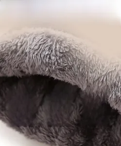 Close-up of thick grey faux fur lining for winter knitted beanie to ensure warmth
