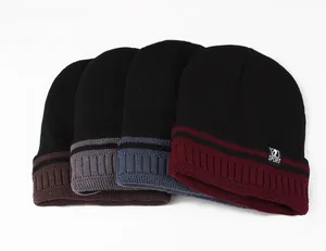 Detail of four colorful knit hats with sport label and stripe pattern for winter wear