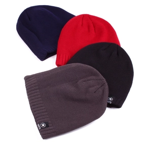 Detailed knit texture of solid color beanies in navy, red, black and grey tones