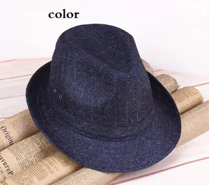 Detail of blue plaid jazz hat with metal eyelets on vintage newspaper background