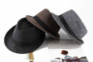 Close-up of herringbone trilby hats in grey and brown with black decorative bands