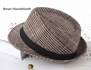 Detail of coffee plaid wool fedora hat with black decorative band on magazine background