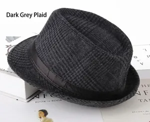 Close-up of dark grey plaid felt fedora hat with black satin band on fashion magazine