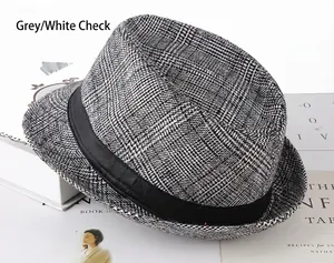 Detail of grey plaid fedora hat with black ribbon trim on minimalist background