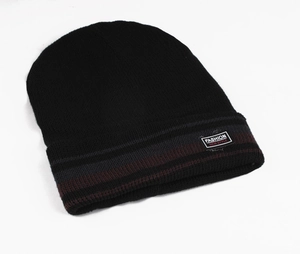 Close-up of black knit beanie with striped cuff and fashion new style textile label