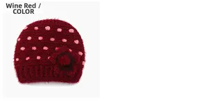 Close-up of wine red knit hat featuring pink dots and a handmade floral detail