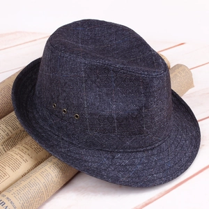Detail of dark blue fedora hat with rhombus texture and metal ventilation eyelets